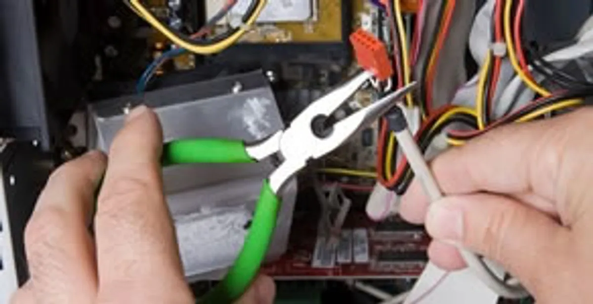 Licensed electrical contractor performing electrical repair with tools in Stanford, CA