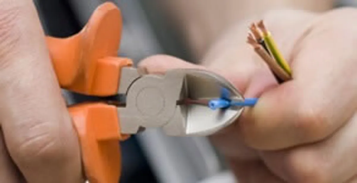licensed electrician performing precise wire cutting and preparation during electrical service in Mountain View, CA